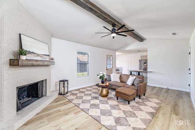 1702 Parkview Dr, San Angelo, TX 76904 - living room featuring light wood-style floors, ceiling fan, a fireplace, and baseboards