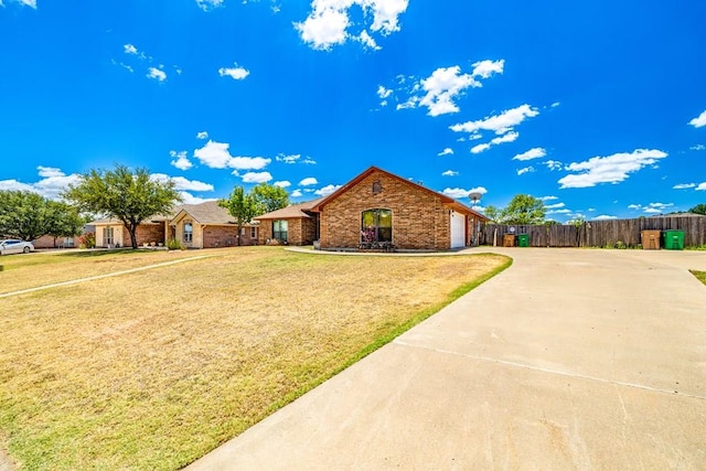 ranch-style house with a garage and a front yard