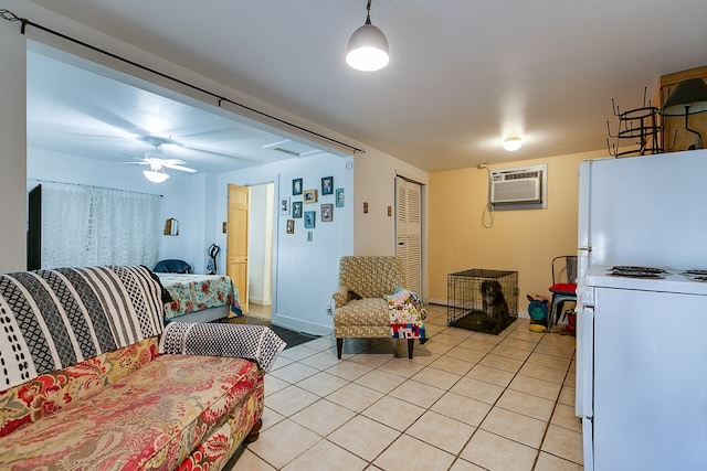 tiled living room featuring a wall unit AC and ceiling fan