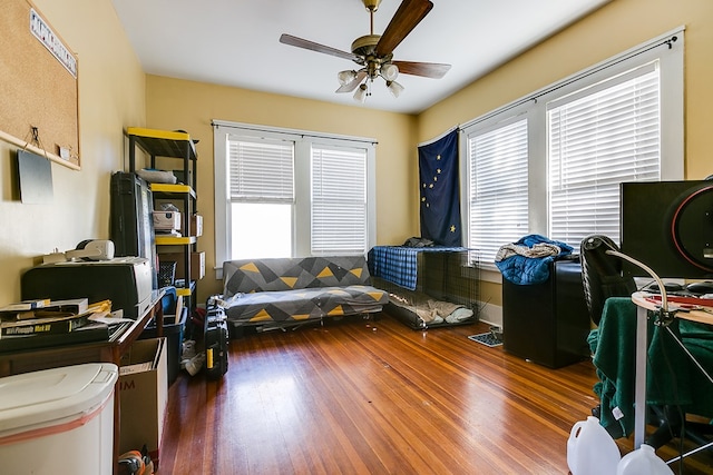 office area with dark hardwood / wood-style flooring, plenty of natural light, and ceiling fan