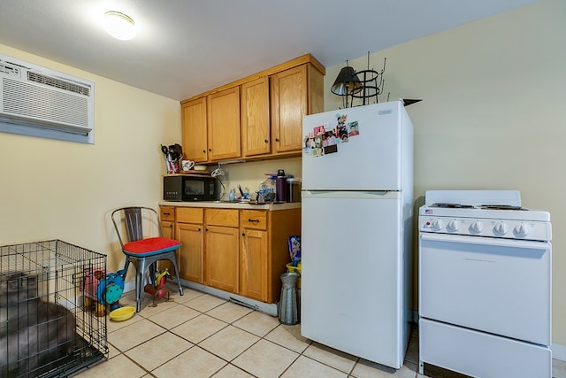 kitchen with white appliances, an AC wall unit, and light tile patterned floors