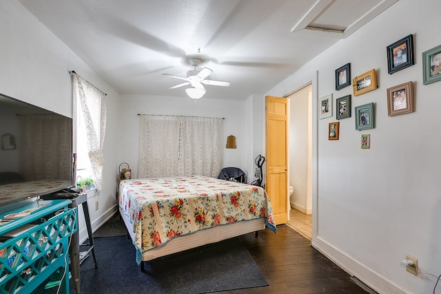 bedroom with multiple windows, dark hardwood / wood-style flooring, connected bathroom, and ceiling fan