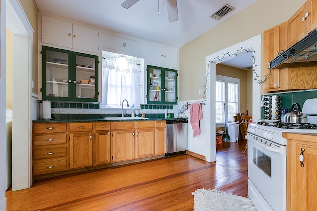 kitchen with tasteful backsplash, white gas range, stainless steel dishwasher, and sink