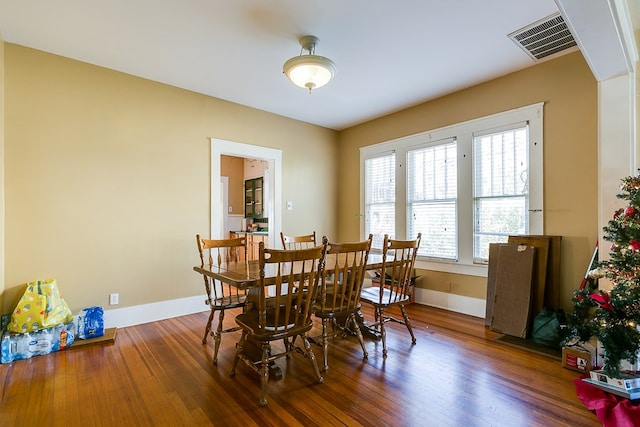 dining space with hardwood / wood-style flooring