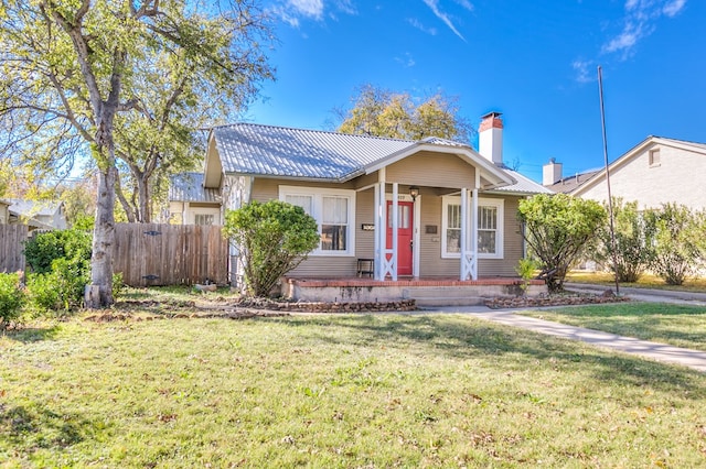 bungalow-style home featuring a front yard