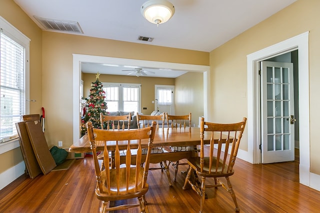 dining area with dark hardwood / wood-style flooring and ceiling fan