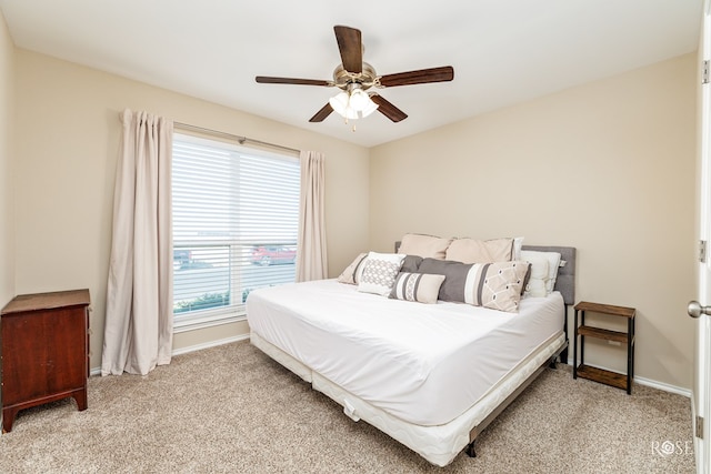 bedroom with ceiling fan and light carpet