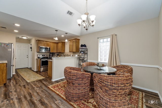 dining space with dark hardwood / wood-style floors, vaulted ceiling, and a notable chandelier