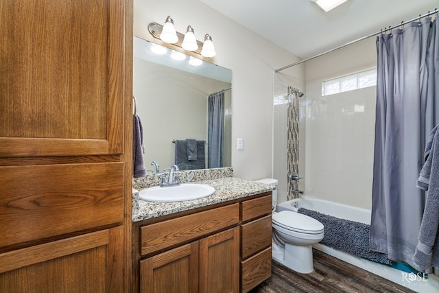 full bathroom featuring vanity, toilet, wood-type flooring, and shower / bath combo with shower curtain