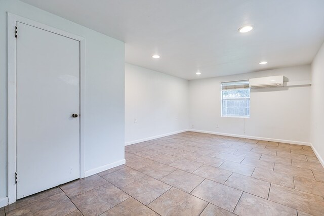 2526 Harvard Ave, San Angelo, TX 76904 - basement featuring a wall unit AC, recessed lighting, and baseboards