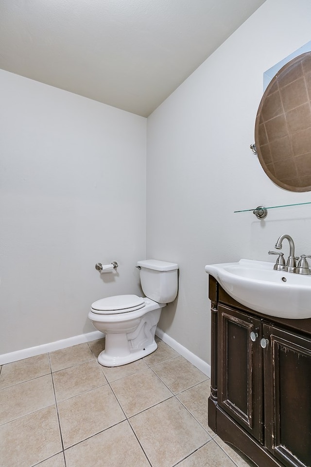 2526 Harvard Ave, San Angelo, TX 76904 - bathroom with tile patterned floors, toilet, baseboards, and vanity