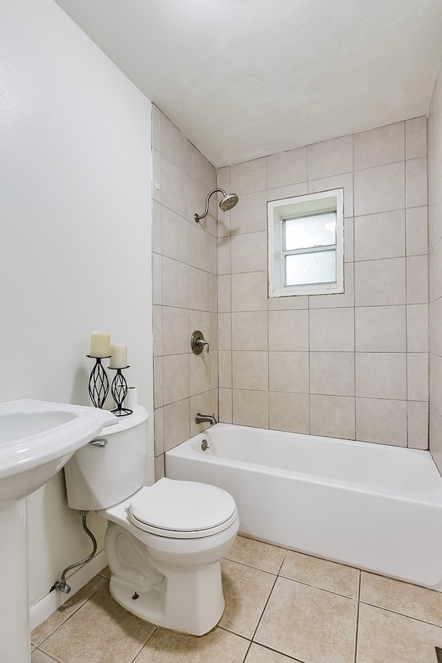 2526 Harvard Ave, San Angelo, TX 76904 - bathroom featuring tile patterned flooring, toilet, shower / bathtub combination, and baseboards