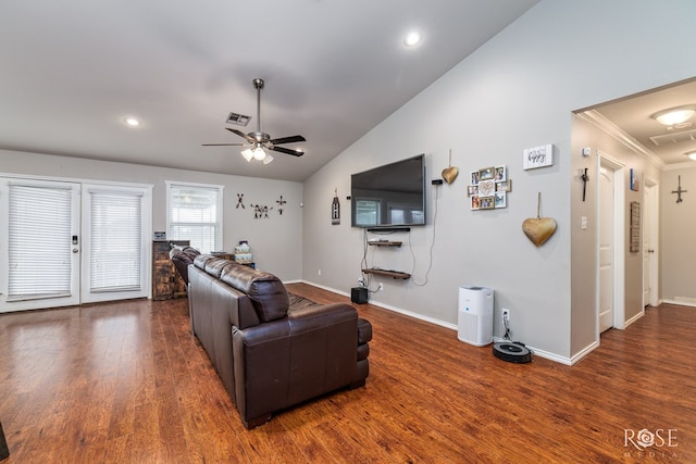 living area featuring visible vents, baseboards, vaulted ceiling, wood finished floors, and a ceiling fan