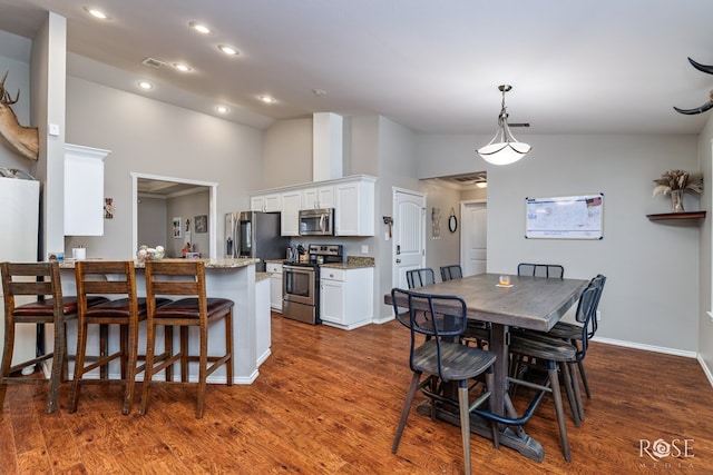 dining area with recessed lighting, baseboards, high vaulted ceiling, and dark wood finished floors