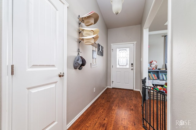 doorway with wood finished floors and baseboards