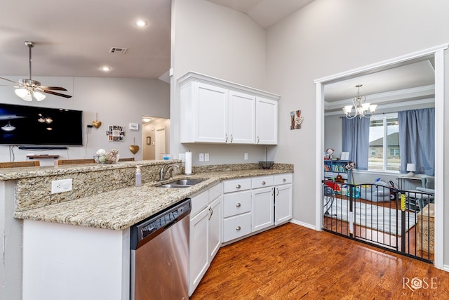 kitchen with stainless steel dishwasher, wood finished floors, white cabinets, a ceiling fan, and a sink