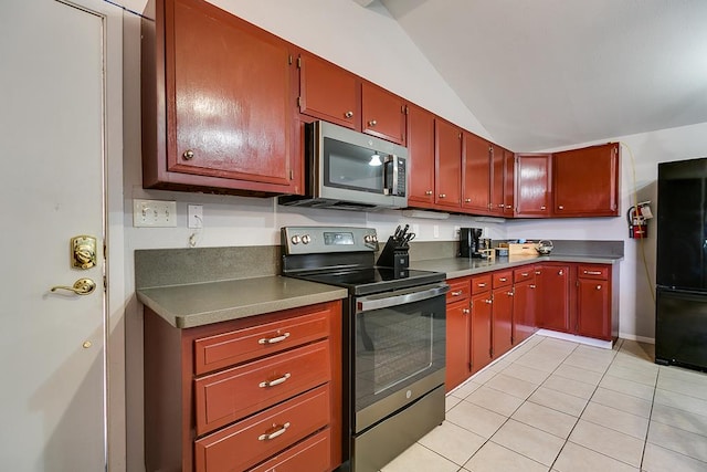 2458 Fishermans Rd, San Angelo, TX 76904 - kitchen featuring appliances with stainless steel finishes, light tile patterned floors, and vaulted ceiling
