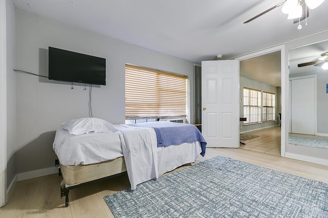 2458 Fishermans Rd, San Angelo, TX 76904 - bedroom with a ceiling fan, wood finished floors, and baseboards