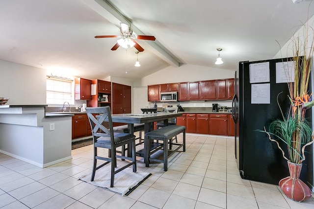 2458 Fishermans Rd, San Angelo, TX 76904 - kitchen featuring stainless steel microwave, freestanding refrigerator, a ceiling fan, light tile patterned floors, and reddish brown cabinets