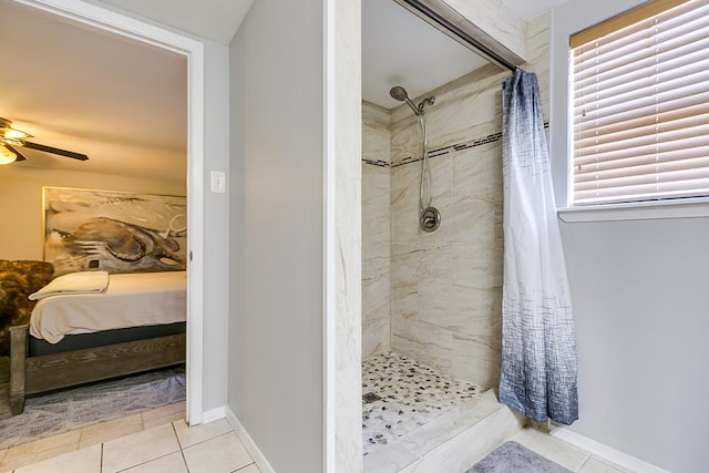 2458 Fishermans Rd, San Angelo, TX 76904 - bathroom featuring a tile shower, tile patterned flooring, and a ceiling fan