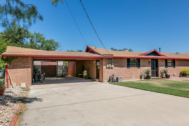 2458 Fishermans Rd, San Angelo, TX 76904 - single story home with brick siding, concrete driveway, an attached carport, and a front yard