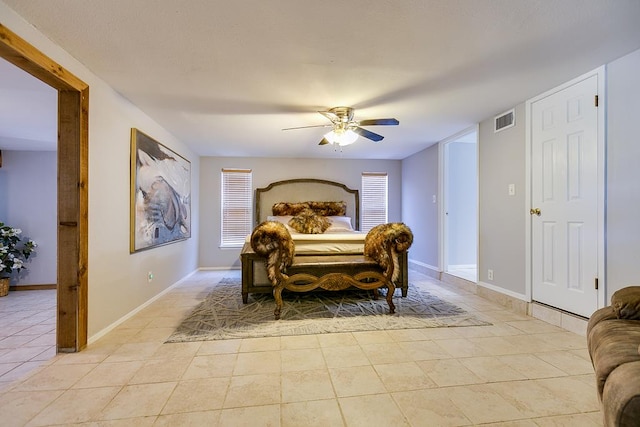 2458 Fishermans Rd, San Angelo, TX 76904 - bedroom with light tile patterned floors, ceiling fan, and baseboards