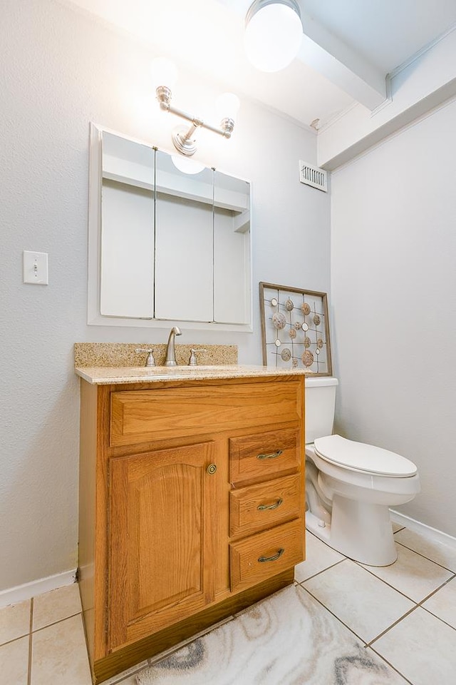 2458 Fishermans Rd, San Angelo, TX 76904 - half bath with tile patterned floors, toilet, vanity, and baseboards