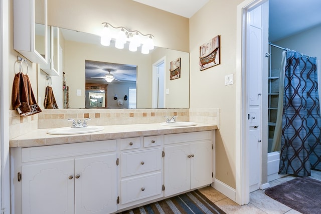 bathroom featuring tile patterned floors, a sink, a ceiling fan, and decorative backsplash