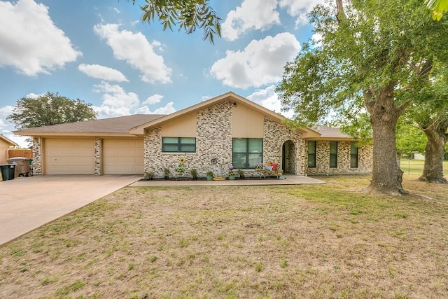 ranch-style home with a garage, driveway, and a front lawn