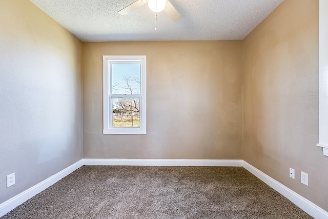 carpeted empty room with ceiling fan and a textured ceiling