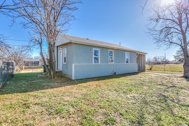 rear view of house featuring a lawn