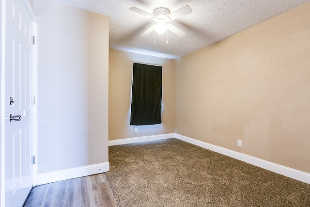 spare room featuring ceiling fan, wood-type flooring, and a textured ceiling