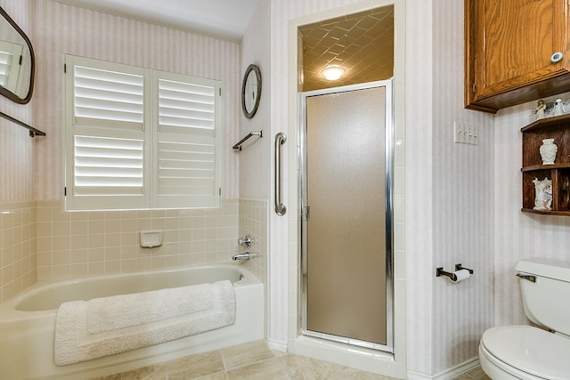 bathroom with tile patterned flooring, toilet, and separate shower and tub