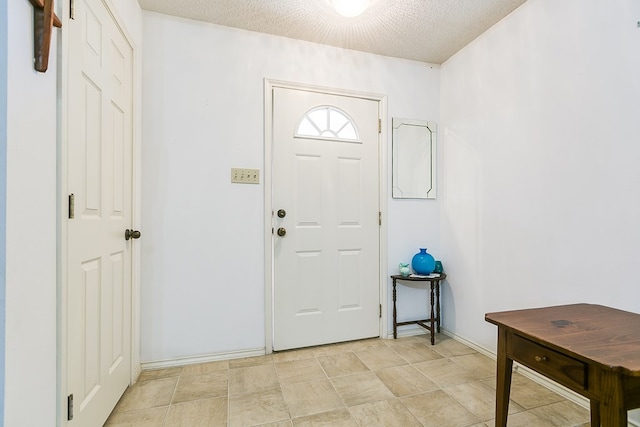 entrance foyer featuring a textured ceiling