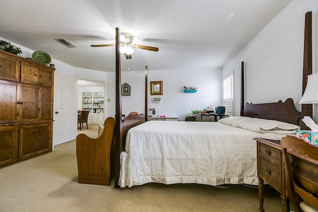 carpeted bedroom with a textured ceiling and ceiling fan