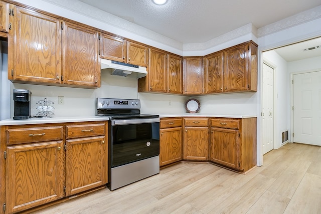 kitchen with light hardwood / wood-style floors, stainless steel range with electric cooktop, and a textured ceiling