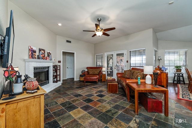 4917 Bermuda Dr, San Angelo, TX 76904 - living area with a ceiling fan, a brick fireplace, stone tile floors, recessed lighting, and french doors