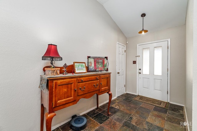4917 Bermuda Dr, San Angelo, TX 76904 - entryway with stone tile flooring, vaulted ceiling, and baseboards