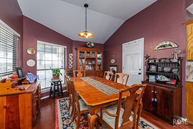 dining room featuring vaulted ceiling, dark wood-style flooring, and baseboards