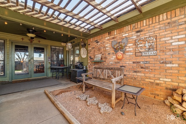 view of patio featuring a ceiling fan, a pergola, and french doors