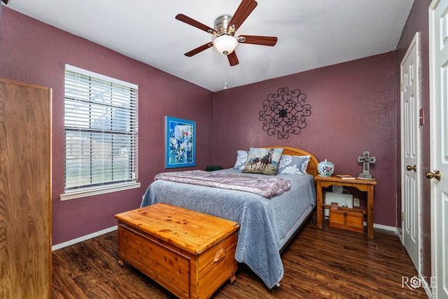 bedroom featuring ceiling fan, a textured wall, wood finished floors, and baseboards