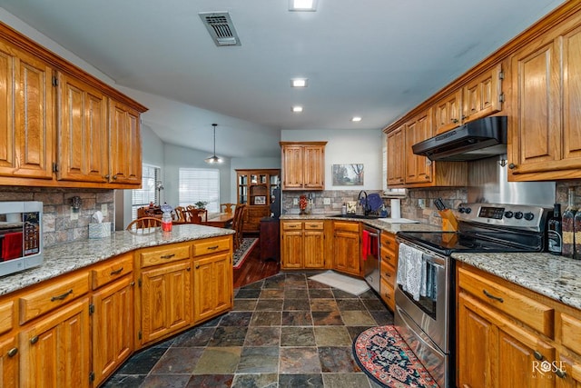 4917 Bermuda Dr, San Angelo, TX 76904 - kitchen featuring appliances with stainless steel finishes, under cabinet range hood, decorative backsplash, brown cabinets, and recessed lighting