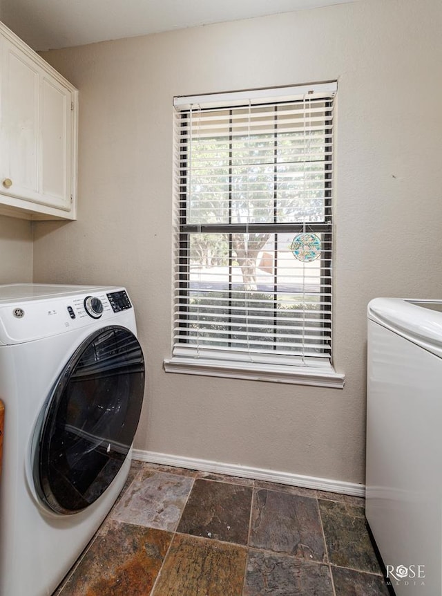 4917 Bermuda Dr, San Angelo, TX 76904 - laundry room with cabinet space, washer and dryer, stone finish floors, and baseboards