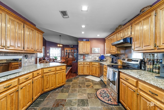 kitchen featuring tasteful backsplash, visible vents, stone finish floor, appliances with stainless steel finishes, and under cabinet range hood