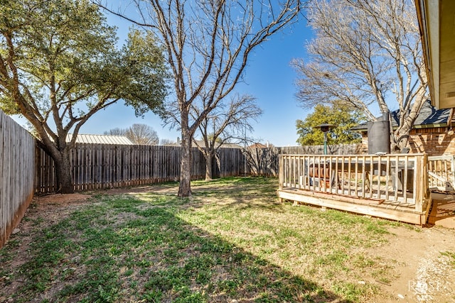 view of yard with a fenced backyard and a deck