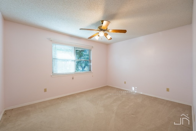 carpeted empty room featuring a textured ceiling and ceiling fan