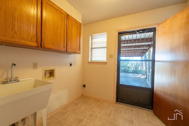 laundry room featuring sink, cabinets, a textured ceiling, washer hookup, and hookup for an electric dryer