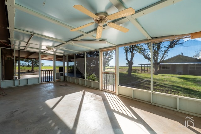 unfurnished sunroom with ceiling fan