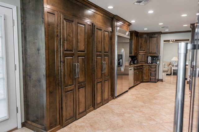 5213 Green Valley Trl, San Angelo, TX 76904 - kitchen featuring appliances with stainless steel finishes, dark brown cabinetry, crown molding, and recessed lighting