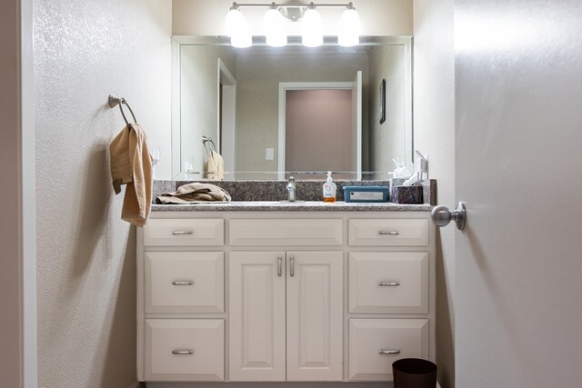 5213 Green Valley Trl, San Angelo, TX 76904 - bathroom featuring vanity and a textured wall